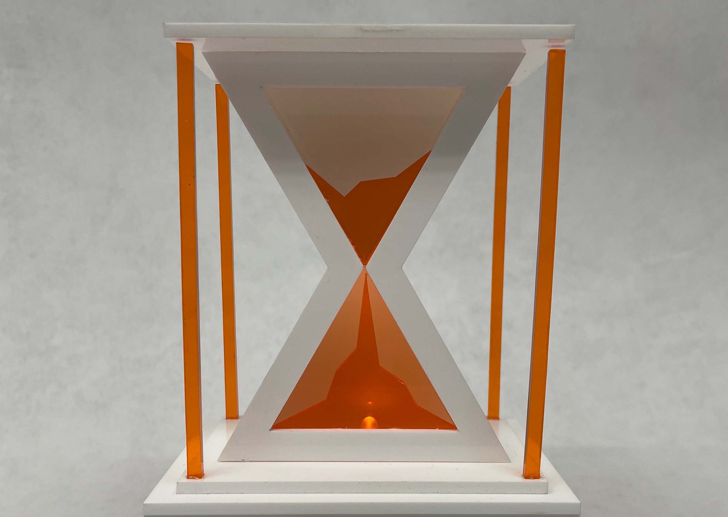 an image of a white and oragne hourglass with an LED light inside made from acrylic